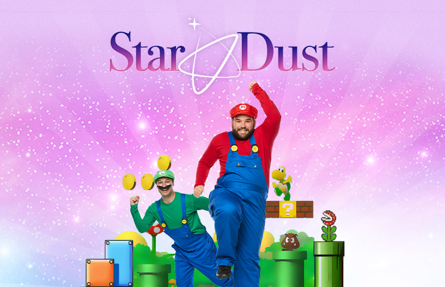 Two male entertainers dressed as Mario and Luigi from the Super Mario video game series, with various characters and elements from the game around them